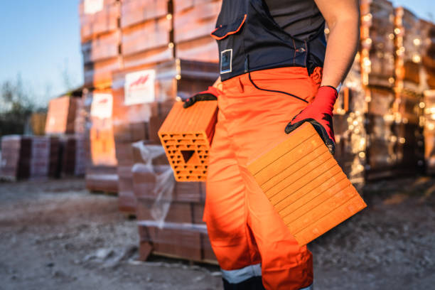 Close-up of construction worker builds stone wall