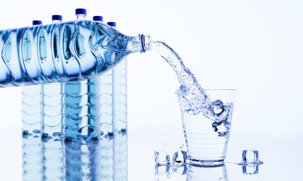 istock Pour water or clean water from a plastic or PET bottle into a drinking glass with ice cubes. Cold drinking water to quench thirst and refresh. 3D rendering 1391319190