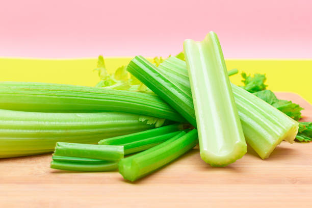 istock Fresh Celery Stem and Chopped Celery Sticks on Wooden Cutting Board 1391323575