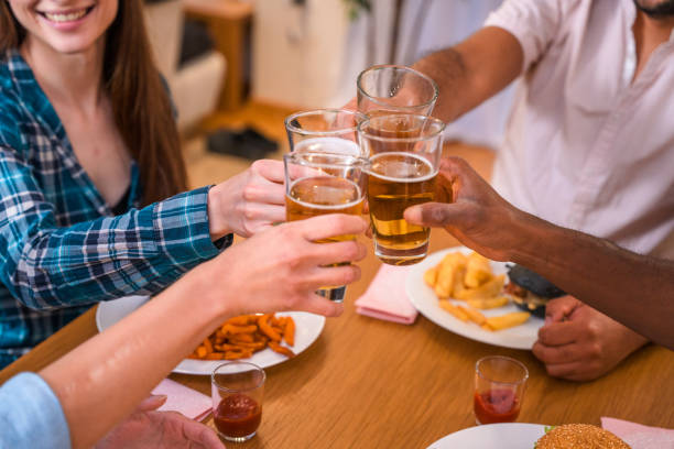 istock Multi-Cultural Group of Friends Toasting At Burger Party 1391324708