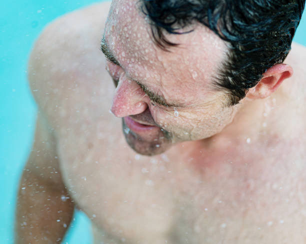 istock Middle age fit man getting wet, taking a shower or bathing 1391331077