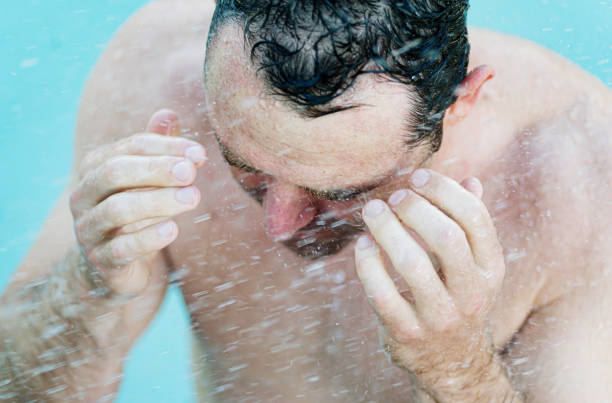 istock Middle age fit man getting wet, taking a shower or bathing 1391331128