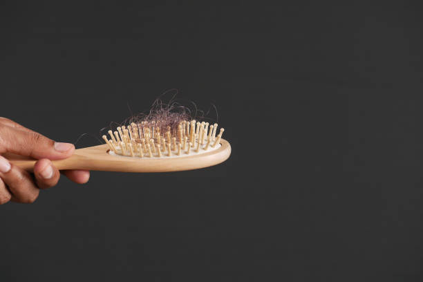 istock man hold his list hair close up 1391333074