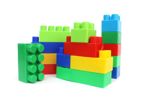 Bright multi-colored cubes of the designer scattered lie on a white isolated background.