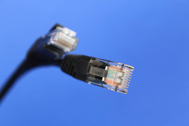 Businessman holding Cat5 network cable.  Focus on cable.
