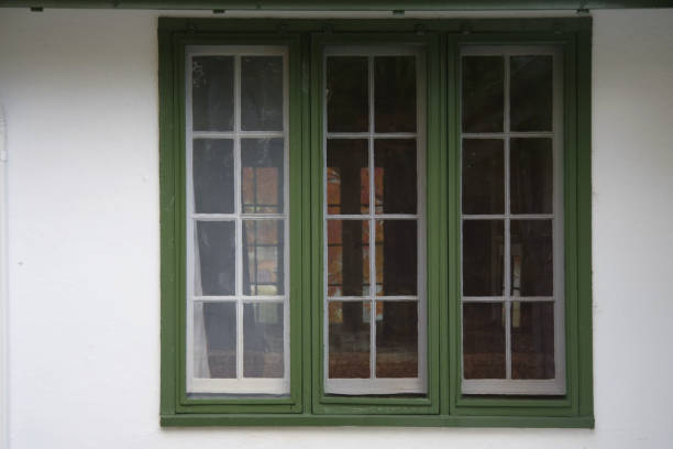 istock Windows with green trim  on white building 1391338163