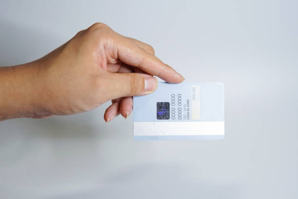 istock a hand holding a credit card 1391338327