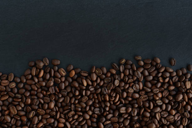 istock Coffee beans on black background. Roasted Coffee beans texture, top view 1391347425