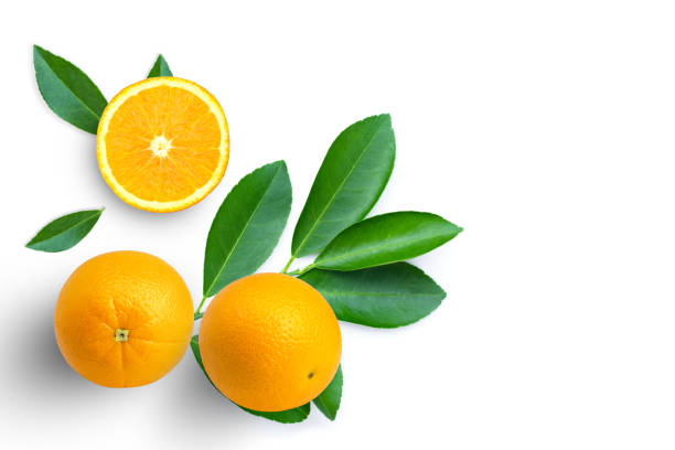 istock Orange fruit with slice and green leaf on white 1391348428