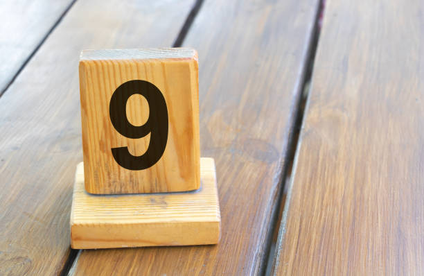 istock Wooden priority number 9 on a plank tab 1391350049