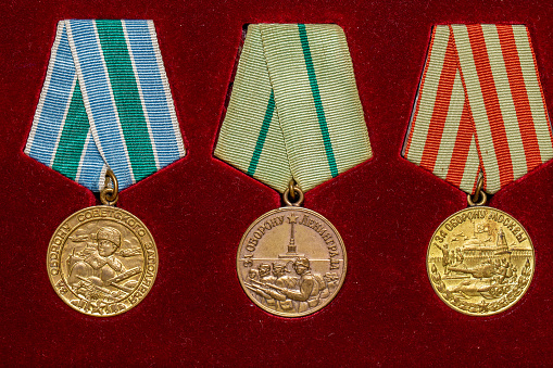 Soviet military medals of World War II on red background