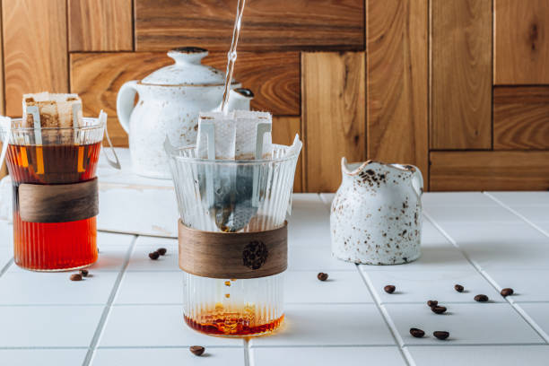 istock Ground drip coffee using paper type filter with coffee beans on white ceramic tiles background 1391354047