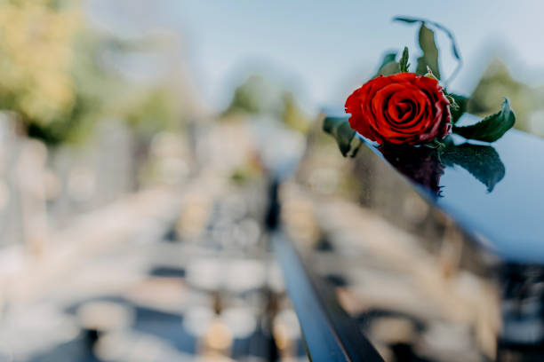istock Headstone In Cemetery With Red Rose Flower. 1391356047