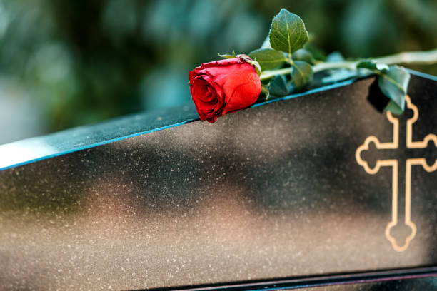 istock Headstone In Cemetery With Red Rose Flower. 1391356296