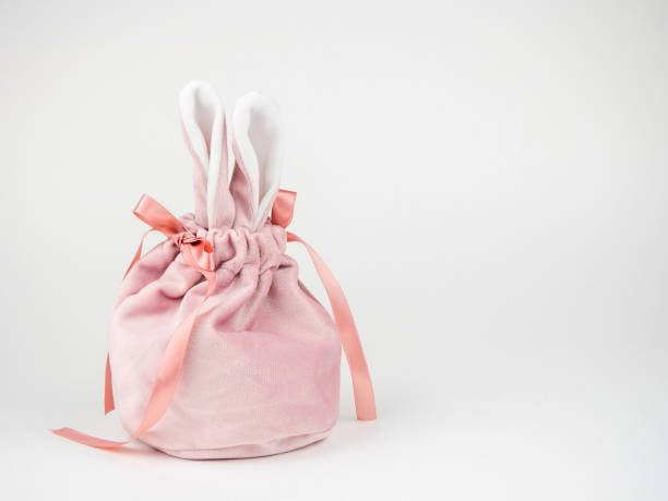 istock Pink baggie with bunny ears for a gift.On a light background with space for text. 1391357116