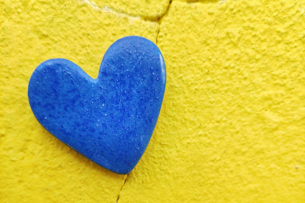 Red heart painted on a house wall.