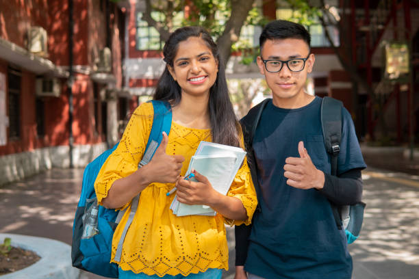 istock Multi ethnic college student looking at the camera with thumbs up and smile. 1391364537
