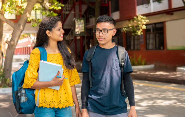 istock Multi ethnic college student walking in college campus and talking. 1391364538
