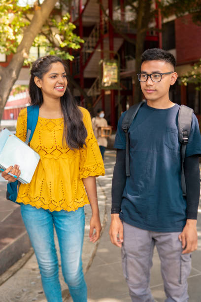 istock Multi ethnic college student walking in college campus and talking. 1391364539