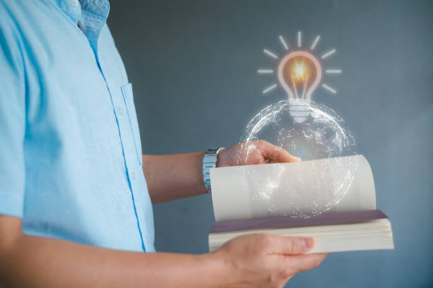 istock Business man reading a book on gray background. 1391365662