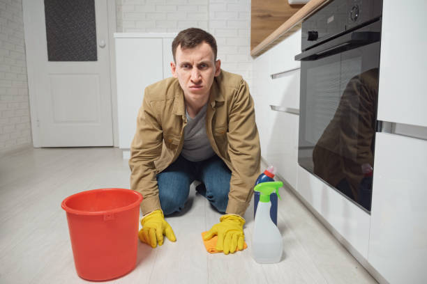 istock Man cleans floor with detergent and water in kitchen 1391369232