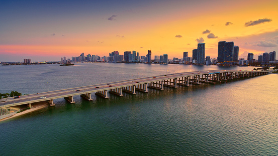Aerial view of Julia Tuttle Causeway with downtown Miami in background during sunset in Florida, USA.