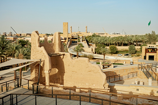 Wide angle view of preserved ruins of At-Turaif and its traditional mud-brick architecture, desert oasis and date palm garden in background. Property release attached.