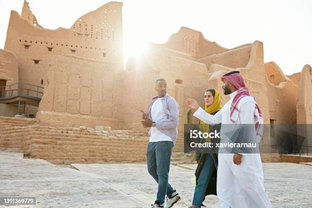 Guide Pointing Out Features Of Diriyah Ruins Near Riyadh Stock Photo - Download Image Now