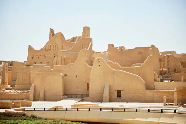 Wide angle view of 18th-century structure, traditional mud-brick architecture, and distinctive Najdi style with decorative triangular windows. Property release attached.