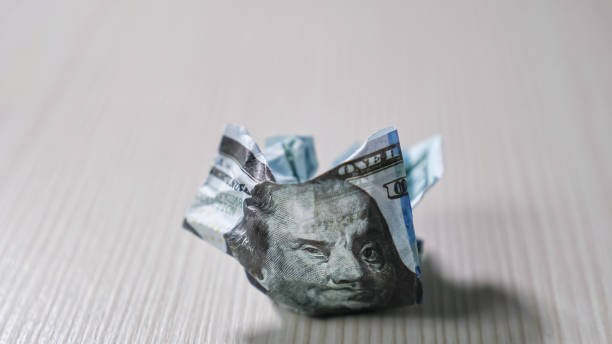 crumpled dollar bill lies on wooden table casting shadow - crumpled currency dollar folded imagens e fotografias de stock