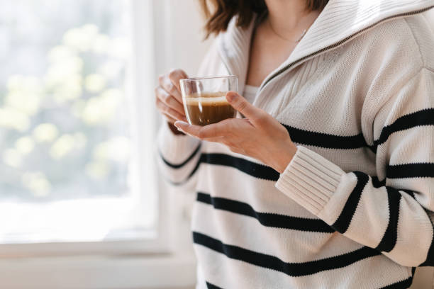 istock Woman drinking coffee by the window on a coffee break 1391371117