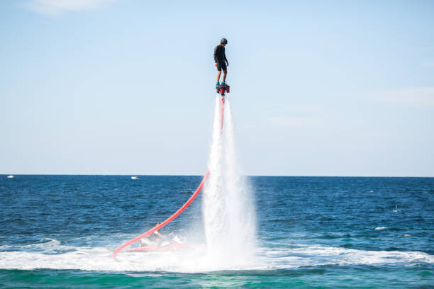 istock A rider on a flyboard in the ocean does difficult stunts. 1391371829