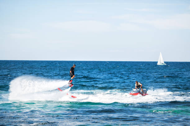 istock A rider on a flyboard in the ocean does difficult stunts. 1391371831