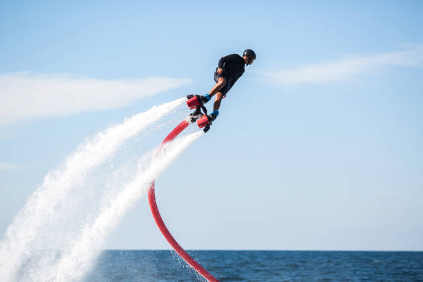 istock A rider on a flyboard in the ocean does difficult stunts. 1391371845