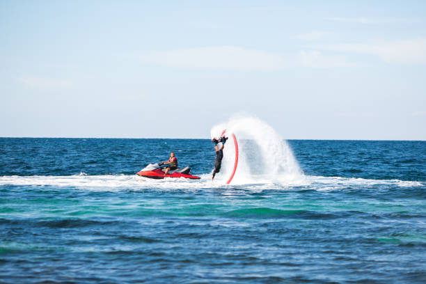 istock A rider on a flyboard in the ocean does difficult stunts. 1391371858