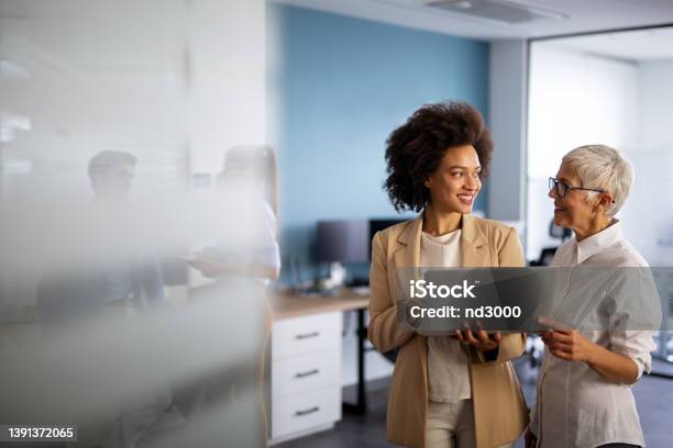 Happy Multiethnic Smiling Business Women Working Together In Office Stock Photo - Download Image Now
