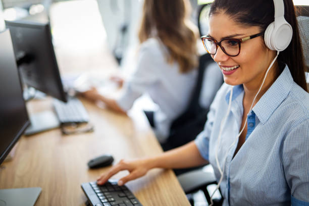 istock Smiling friendly female call-center agent with headset working on support hotline in the office 1391372144