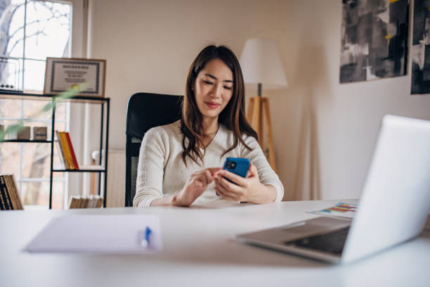 istock Japanese woman working from home and using mobile phone 1391372570