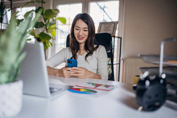 istock Japanese woman working from home and using mobile phone 1391373726