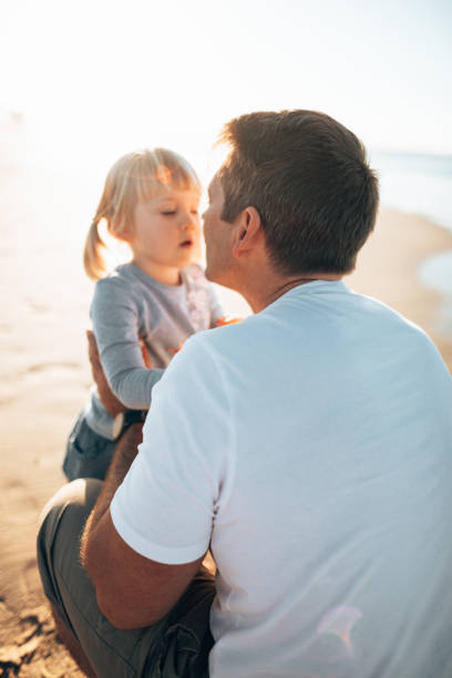 istock dad and daughter embracing on the beach 1391373881
