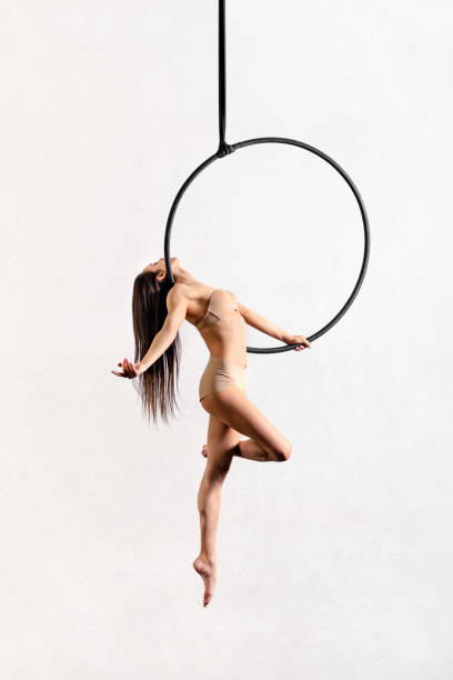 istock Fit woman performing pose on aerial hoop 1391376227