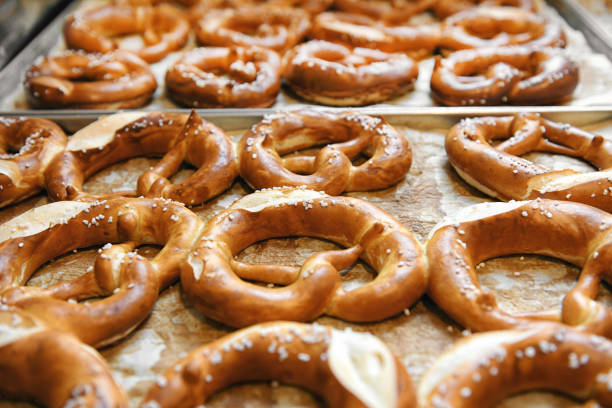 istock Tasty cooked pretzels on trays 1391376423