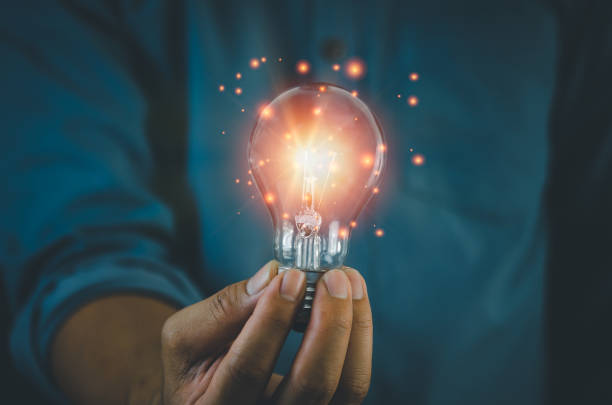 istock hand hold light bulb on black background.Inspiration and Creativity Concepts. 1391378634