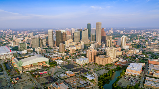 Aerial view of skyscrapers in downtown Houston against cloudy sky, Texas, USA.