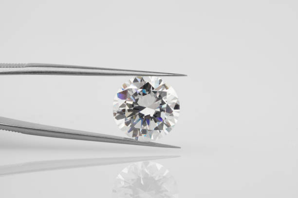 istock Big Diamond Held Horizontally in Tweezers 1391382482