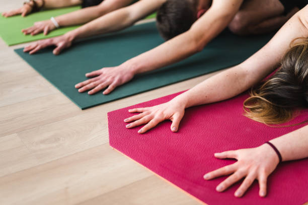 istock Group of young adults stretching on exercise mat 1391382571