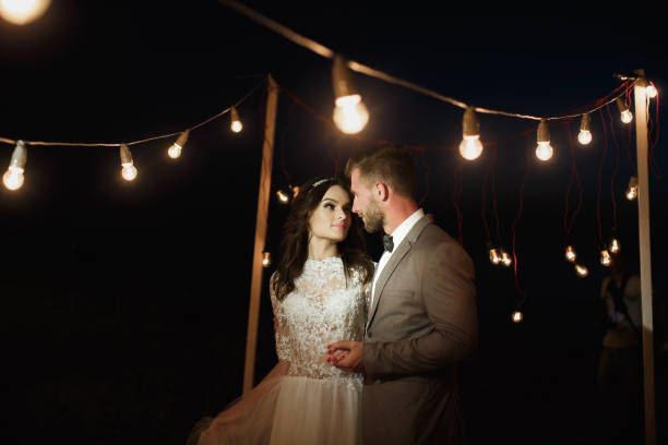istock Night wedding ceremony. The bride and groom hugging 1391385464