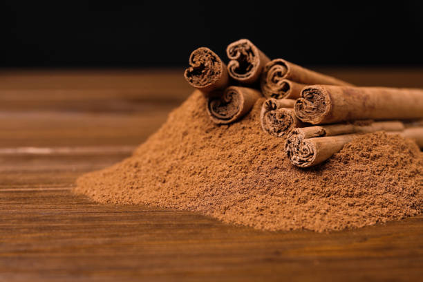 istock Aromatic cinnamon sticks and powder on wooden table, closeup 1391391504