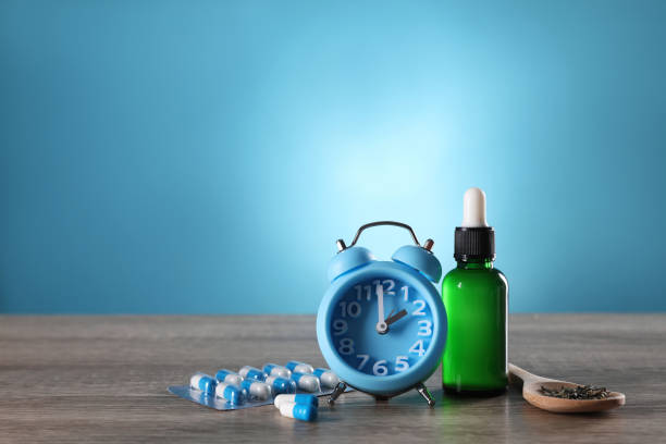 istock Alarm clock and insomnia remedies on wooden table. Space for text 1391392574