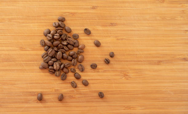 istock Coffee beans on a wood plank 1391392594